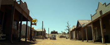 Movie still from “The Dressmaker” (2015), directed by Jocelyn Moorhouse – An old car driving down a dirt road in the middle of nowhere; Extreme Wide shot, Low angle