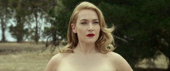Movie still from “The Dressmaker” (2015), directed by Jocelyn Moorhouse – A woman with blonde hair and red lipstick; Close Up shot, Low angle
