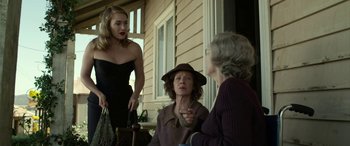 Movie still from “The Dressmaker” (2015), directed by Jocelyn Moorhouse – Three women are sitting on the porch of a house; Medium shot, Over the shoulder angle