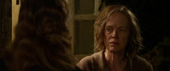 Movie still from “The Dressmaker” (2015), directed by Jocelyn Moorhouse – An older woman looking at herself in the mirror; Close Up shot, Over the shoulder angle