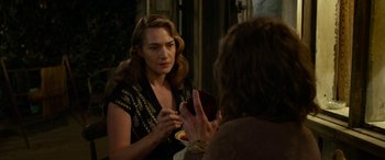 Movie still from “The Dressmaker” (2015), directed by Jocelyn Moorhouse – A woman looking at her reflection in a mirror; Medium shot, Over the shoulder angle