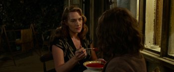 Movie still from “The Dressmaker” (2015), directed by Jocelyn Moorhouse – A woman sitting at a table with a bowl of soup in front of her; Medium shot, Over the shoulder angle
