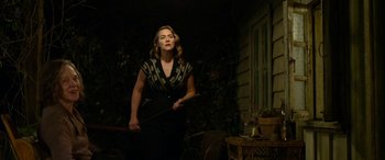 Movie still from “The Dressmaker” (2015), directed by Jocelyn Moorhouse – A woman holding a cane in a dark room; Medium shot, Low angle