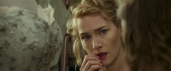 Movie still from “The Dressmaker” (2015), directed by Jocelyn Moorhouse – A person with her hand on her chin; Close Up shot, Over the shoulder angle
