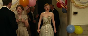 Movie still from “The Dressmaker” (2015), directed by Jocelyn Moorhouse – A woman in a white dress standing in front of a crowd; Medium shot, Low angle