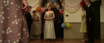 Movie still from “The Dressmaker” (2015), directed by Jocelyn Moorhouse – A woman standing in front of a doorway with balloons; Medium shot, Low angle