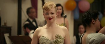 Movie still from “The Dressmaker” (2015), directed by Jocelyn Moorhouse – A woman in a strapless dress with a flower on her chest; Close Up shot, Over the shoulder angle