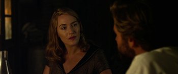 Movie still from “The Dressmaker” (2015), directed by Jocelyn Moorhouse – A woman sitting in front of a man in front of a mirror; Close Up shot, Over the shoulder angle