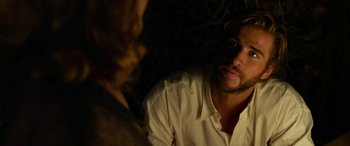Movie still from “The Dressmaker” (2015), directed by Jocelyn Moorhouse – A man and a woman sitting in front of each other in a dark room; Close Up shot, Over the shoulder angle