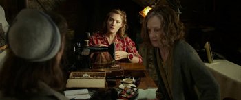 Movie still from “The Dressmaker” (2015), directed by Jocelyn Moorhouse – Two women sitting at a table with sewing machines; Medium shot, Over the shoulder angle