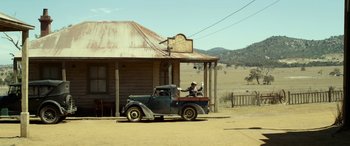 Movie still from “The Dressmaker” (2015), directed by Jocelyn Moorhouse – An old truck parked in front of a house; Extreme Wide shot, Low angle