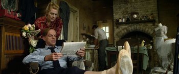 Movie still from “The Dressmaker” (2015), directed by Jocelyn Moorhouse – A man and a woman looking at a newspaper; Medium shot, Low angle