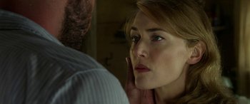 Movie still from “The Dressmaker” (2015), directed by Jocelyn Moorhouse – A woman looking at a man in the mirror; Close Up shot, Over the shoulder angle