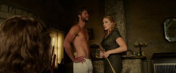 Movie still from “The Dressmaker” (2015), directed by Jocelyn Moorhouse – A man standing next to a woman in a living room; Medium shot, Low angle