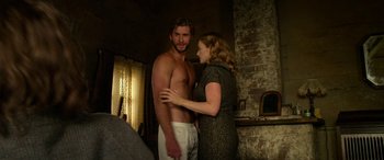 Movie still from “The Dressmaker” (2015), directed by Jocelyn Moorhouse – A man and a woman standing next to each other in a room; Medium shot, Over the shoulder angle