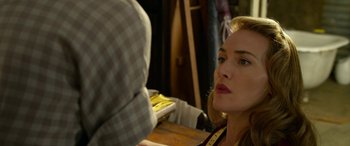 Movie still from “The Dressmaker” (2015), directed by Jocelyn Moorhouse – A person sitting at a table; Close Up shot, Over the shoulder angle
