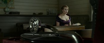 Movie still from “The Dressmaker” (2015), directed by Jocelyn Moorhouse – A woman sitting in front of an old record player; Medium shot, Low angle