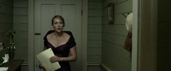 Movie still from “The Dressmaker” (2015), directed by Jocelyn Moorhouse – A woman in a purple dress holding a piece of paper; Medium shot, Low angle
