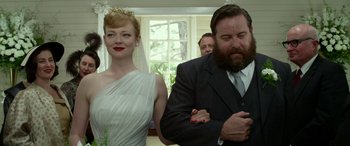 Movie still from “The Dressmaker” (2015), directed by Jocelyn Moorhouse – A man and a woman standing next to each other in front of a window; Medium shot, Low angle