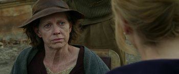 Movie still from “The Dressmaker” (2015), directed by Jocelyn Moorhouse – An older woman wearing a hat looking into a mirror; Close Up shot, Over the shoulder angle