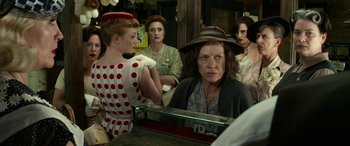 Movie still from “The Dressmaker” (2015), directed by Jocelyn Moorhouse – A group of women sitting in front of a mirror; Medium shot, Over the shoulder angle