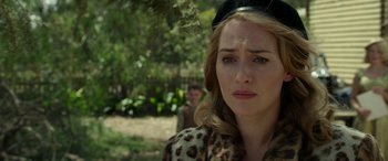 Movie still from “The Dressmaker” (2015), directed by Jocelyn Moorhouse – A person wearing a leopard print jacket; Close Up shot, Over the shoulder angle