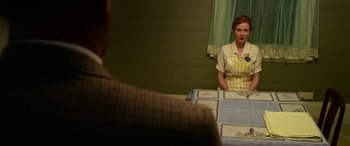 Movie still from “The Dressmaker” (2015), directed by Jocelyn Moorhouse – A woman standing in front of a mirror in front of a man; Medium shot, Over the shoulder angle