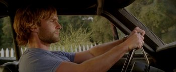 Movie still from “The Dukes of Hazzard” (2005), directed by Jay Chandrasekhar – A man driving a car in a driveway; Close Up shot, Over the shoulder angle