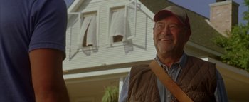 Movie still from “The Dukes of Hazzard” (2005), directed by Jay Chandrasekhar – An older man standing in front of a house; Medium shot, Low angle