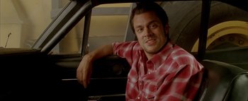 Movie still from “The Dukes of Hazzard” (2005), directed by Jay Chandrasekhar – A man sitting in the back seat of a car; Close Up shot, Over the shoulder angle