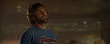 Movie still from “The Dukes of Hazzard” (2005), directed by Jay Chandrasekhar – A man with long hair is smiling for the camera; Close Up shot, Low angle