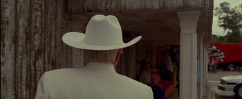 Movie still from “The Dukes of Hazzard” (2005), directed by Jay Chandrasekhar – A man wearing a white cowboy hat in front of a crowd; Close Up shot, Over the shoulder angle