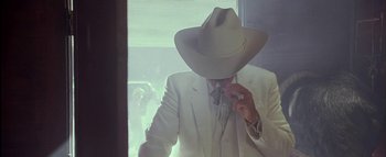 Movie still from “The Dukes of Hazzard” (2005), directed by Jay Chandrasekhar – A man in a white suit and a cowboy hat; Close Up shot, Low angle