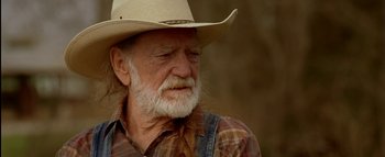 Movie still from “The Dukes of Hazzard” (2005), directed by Jay Chandrasekhar – An old man with a long white beard wearing a cowboy hat; Close Up shot, Low angle