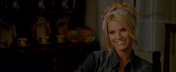 Movie still from “The Dukes of Hazzard” (2005), directed by Jay Chandrasekhar – A woman with blonde hair wearing a bandana smiling for the camera; Close Up shot, Over the shoulder angle