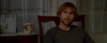 Movie still from “The Dukes of Hazzard” (2005), directed by Jay Chandrasekhar – A man sitting in a wooden chair in front of a window; Close Up shot, Over the shoulder angle