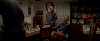 Movie still from “The Dukes of Hazzard” (2005), directed by Jay Chandrasekhar – An old man and a young woman sitting at a dinner table; Wide shot, Over the shoulder angle