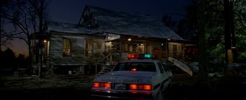Movie still from “The Dukes of Hazzard” (2005), directed by Jay Chandrasekhar – A car parked in front of an old house; Extreme Wide shot, Low angle