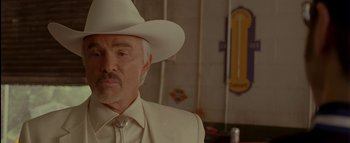 Movie still from “The Dukes of Hazzard” (2005), directed by Jay Chandrasekhar – An older man wearing a white suit and a white hat; Close Up shot, Low angle