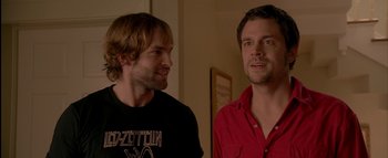 Movie still from “The Dukes of Hazzard” (2005), directed by Jay Chandrasekhar – A couple of men standing next to each other; Close Up shot, Over the shoulder angle