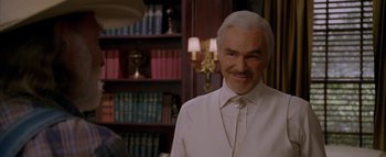 Movie still from “The Dukes of Hazzard” (2005), directed by Jay Chandrasekhar – A man that is wearing a white shirt and tie; Close Up shot, Over the shoulder angle