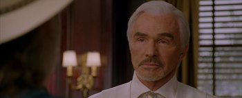 Movie still from “The Dukes of Hazzard” (2005), directed by Jay Chandrasekhar – A man with a white hair and a white shirt; Close Up shot, Over the shoulder angle