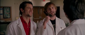 Movie still from “The Dukes of Hazzard” (2005), directed by Jay Chandrasekhar – A couple of men standing next to each other in lab coats; Close Up shot, Low angle