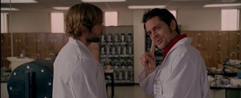 Movie still from “The Dukes of Hazzard” (2005), directed by Jay Chandrasekhar – Two men in white lab coats talking in a room; Close Up shot, Over the shoulder angle