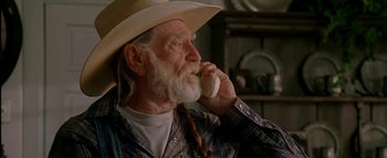 Movie still from “The Dukes of Hazzard” (2005), directed by Jay Chandrasekhar – An old man with a long white beard talking on a cell phone; Close Up shot, Low angle