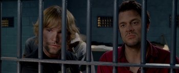 Movie still from “The Dukes of Hazzard” (2005), directed by Jay Chandrasekhar – Two men sitting next to each other in a jail cell; Close Up shot, Over the shoulder angle