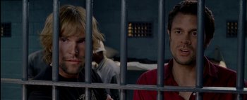 Movie still from “The Dukes of Hazzard” (2005), directed by Jay Chandrasekhar – Two men sitting next to each other behind a fence; Close Up shot, Over the shoulder angle