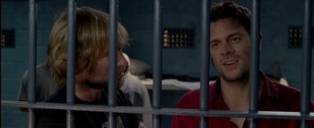 Movie still from “The Dukes of Hazzard” (2005), directed by Jay Chandrasekhar – Two men sitting next to each other in a jail cell; Close Up shot, Over the shoulder angle