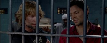 Movie still from “The Dukes of Hazzard” (2005), directed by Jay Chandrasekhar – Two men are standing behind bars in a jail cell; Close Up shot, Over the shoulder angle