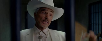 Movie still from “The Dukes of Hazzard” (2005), directed by Jay Chandrasekhar – A person wearing a white hat; Close Up shot, Over the shoulder angle